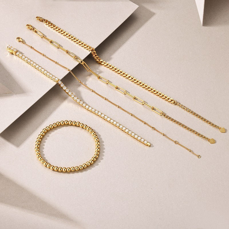Gold bracelets on a light beige background