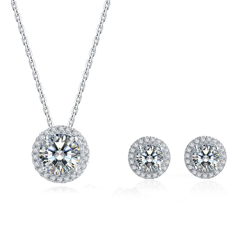 Diamond necklace and earrings set on a white background