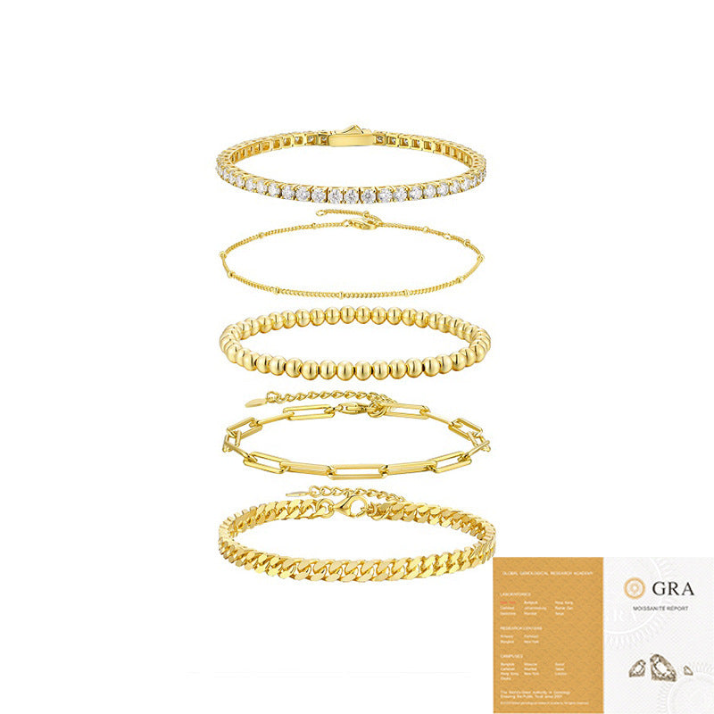 Set of gold bracelets on a white background with a GRA certification card.