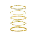 Set of five gold bracelets on a white background