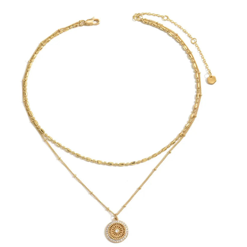 Gold necklace with a pendant on a white background